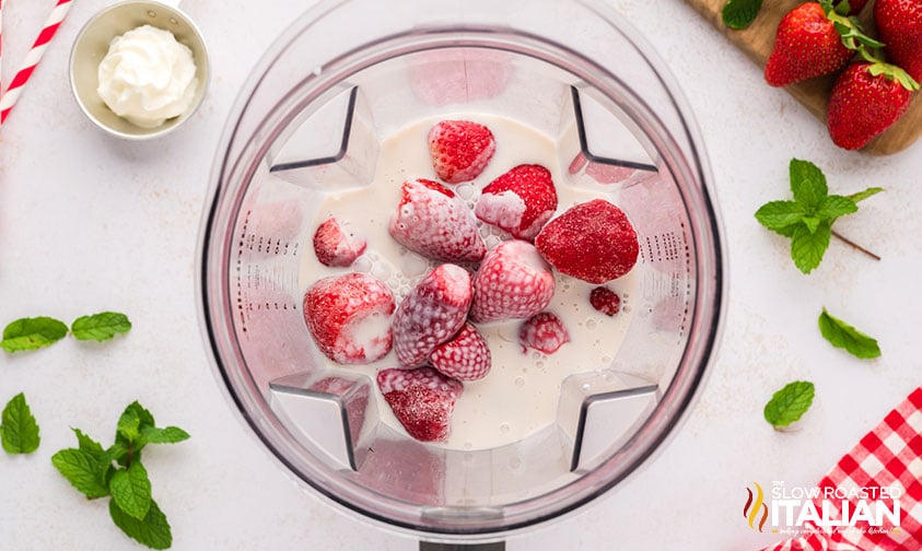 frozen strawberries and creamer in blender