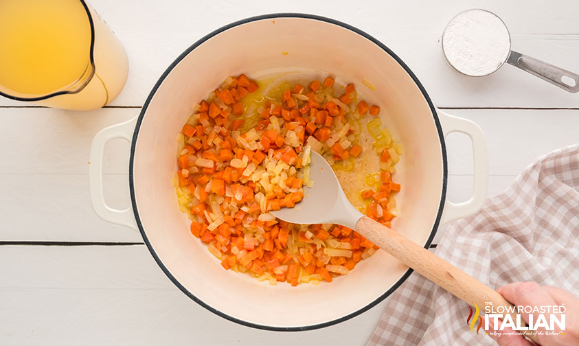 carrots and onion sauteed in large pot with butter