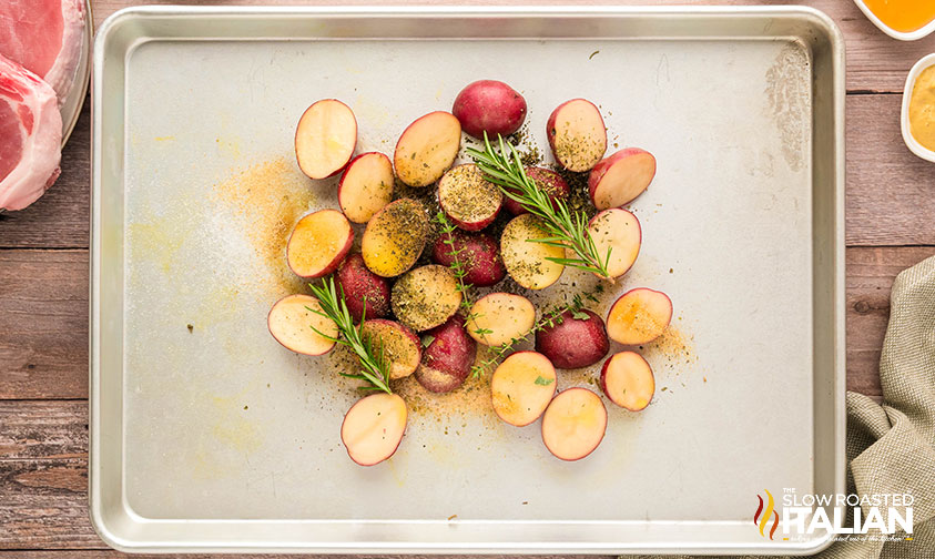 potatoes and rosemary on a baking sheet