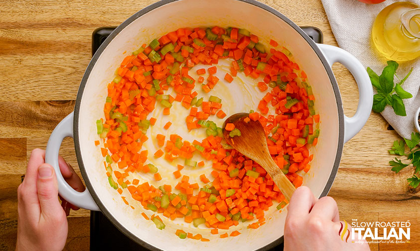 sautéing carrots and celery in a large pot