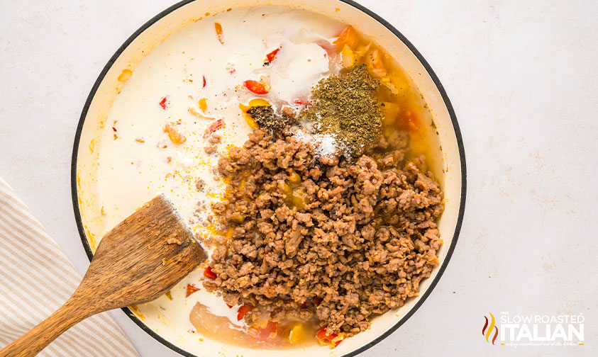 sausage, peppers and heavy cream added to skillet