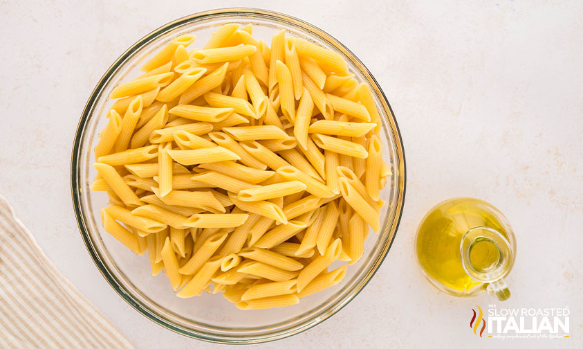 cooked pasta in a large bowl with olive oil