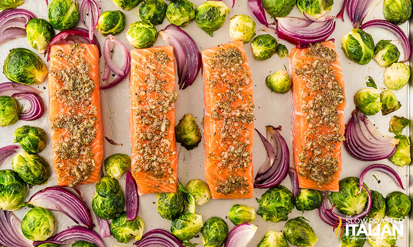 add salmon to baking sheet with roasted veggies