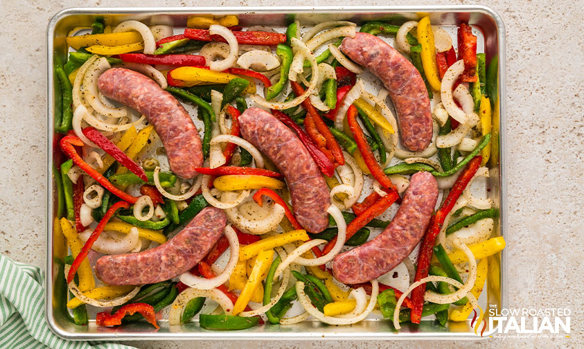 adding sausage to sheet pan