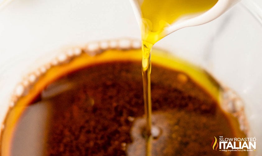 adding olive oil to Simple Balsamic Vinaigrette Recipe