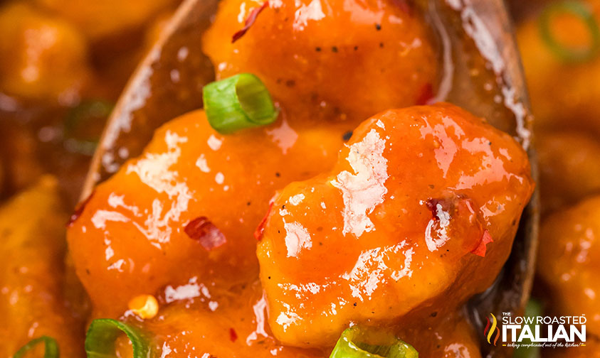 closeup of firecracker chicken on a wooden spoon