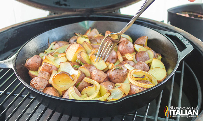 red potatoes in a cast iron skillet on the smoker