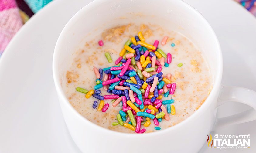 rainbow sprinkles on top of mug cake batter