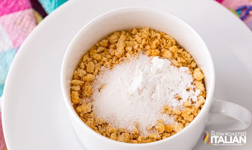 vanilla cookie crumbs, sugar, and baking powder in a white mug