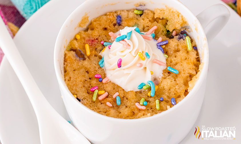 golden oreo funfetti mug cake topped with whipped cream