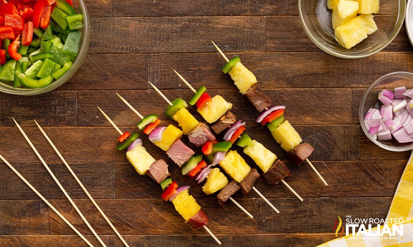 ham, pineapple, bell peppers, and onion on wooden skewers