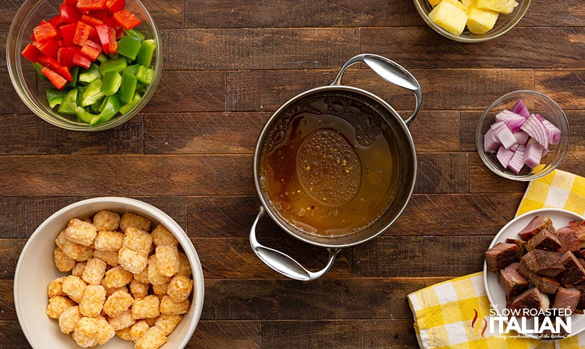 glaze for hawaiian kabobs in small pot surrounded by ingredients